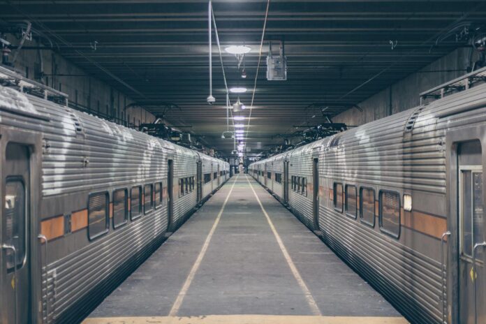 Symmetrical view of an empty railway station in Chicago with trains on both sides.