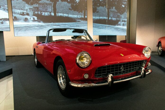 a red sports car on display in a museum